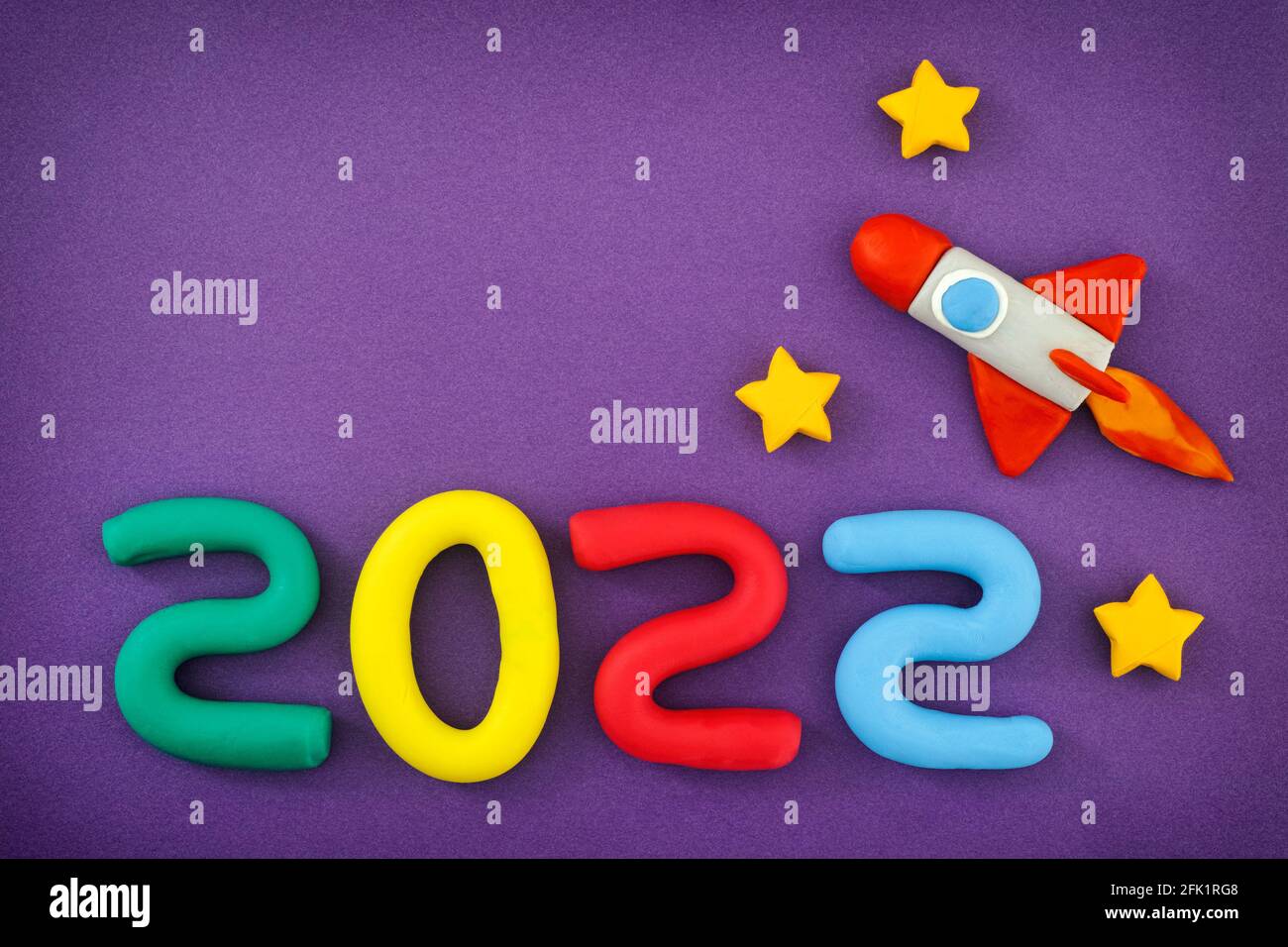 The New Year 2022. The space rocket and Numbers are made out of play clay (plasticine). Stock Photo