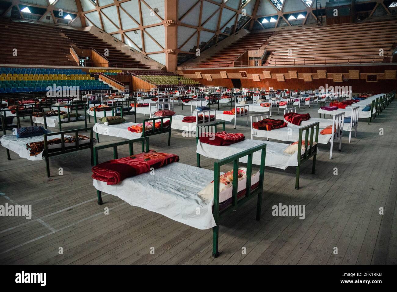 Srinagar, India. 27th Apr, 2021. Beds are placed to set up a Covid-19 isolation centre inside an indoor sports stadium in Srinagar. The Jammu and Kashmir reported 3,164 positive cases, highest ever since the outbreak of Covid-19 pandemic last year, pushing the number of active cases to 22,283 which otherwise were less than 600 around a month before. A 20 year old woman was reported among the Twenty five deaths in J&K in the last 24 hours taking the death toll to 2,197. (Photo by Idrees Abbas/SOPA Images/Sipa USA) Credit: Sipa USA/Alamy Live News Stock Photo