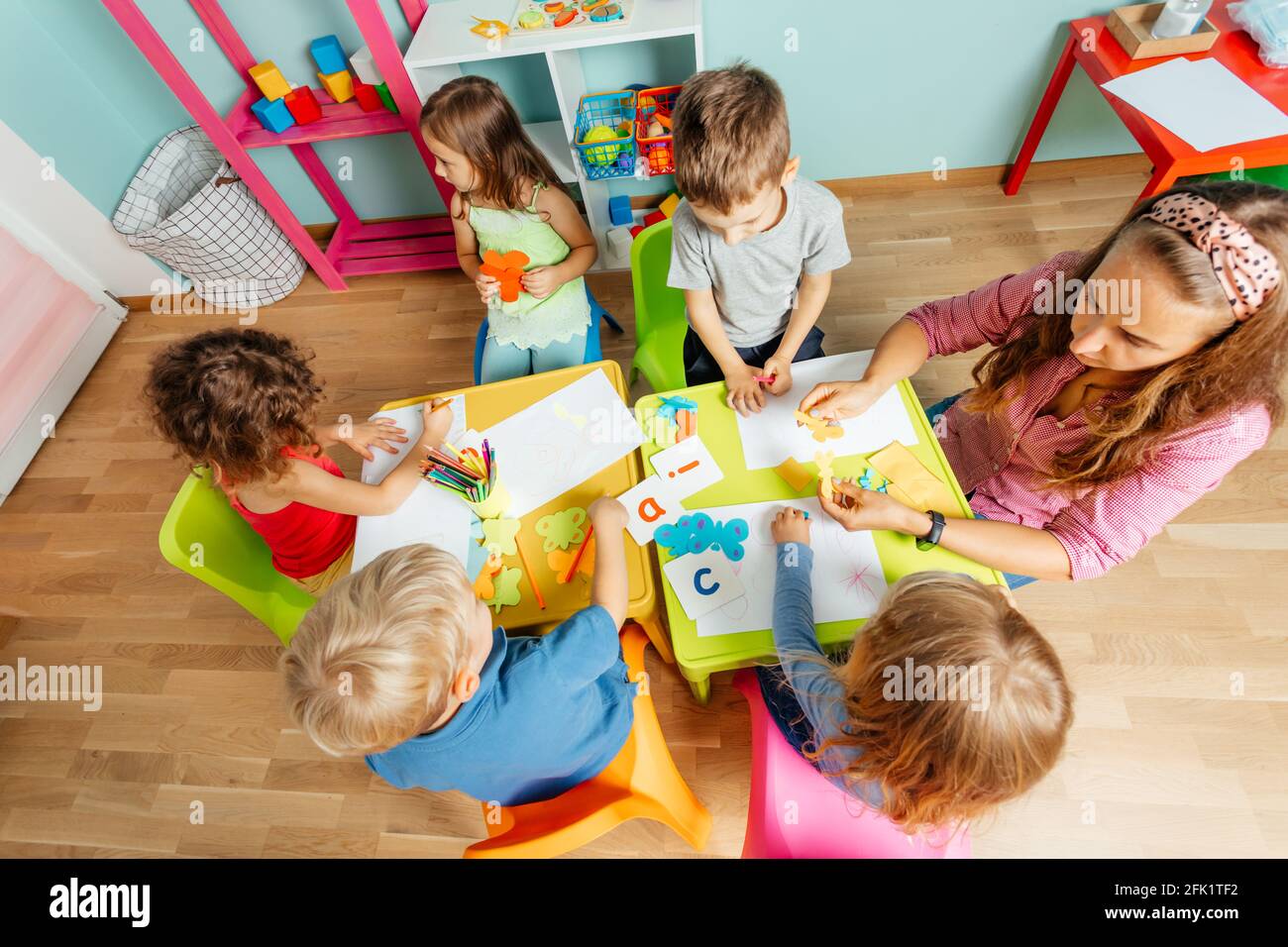 Happy little girl showing her drawing to the camera Stock Photo - Alamy