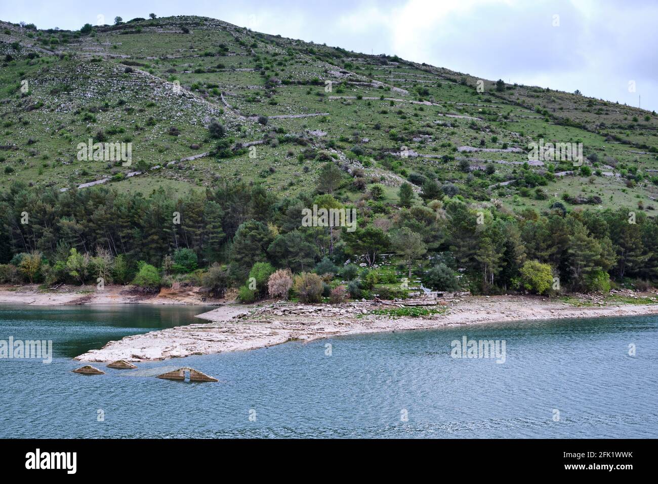 Lago di Santa Rosalia. Artificial lake and reservoir in the Iblei Mountains in the Ragusa region of Sicily. Rooftops of the submerged building showing. Stock Photo