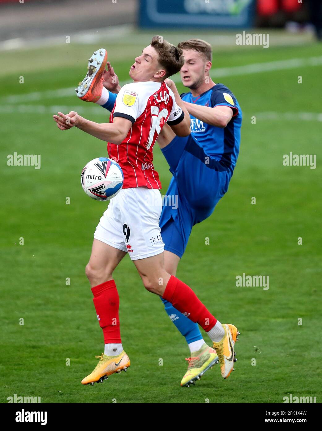 Carlisle United's Jack Armer (right) and Cheltenham Town's George Lloyd battle for the ball during the Sky Bet League Two match at the Jonny-Rocks Stadium, Cheltenham. Picture date: Tuesday April 27, 2021. Stock Photo