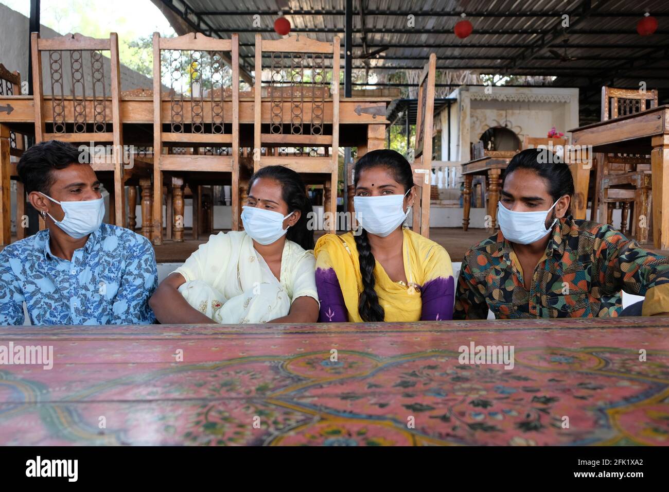 Group of young Indian friends wearing medical face masks having fun in ...