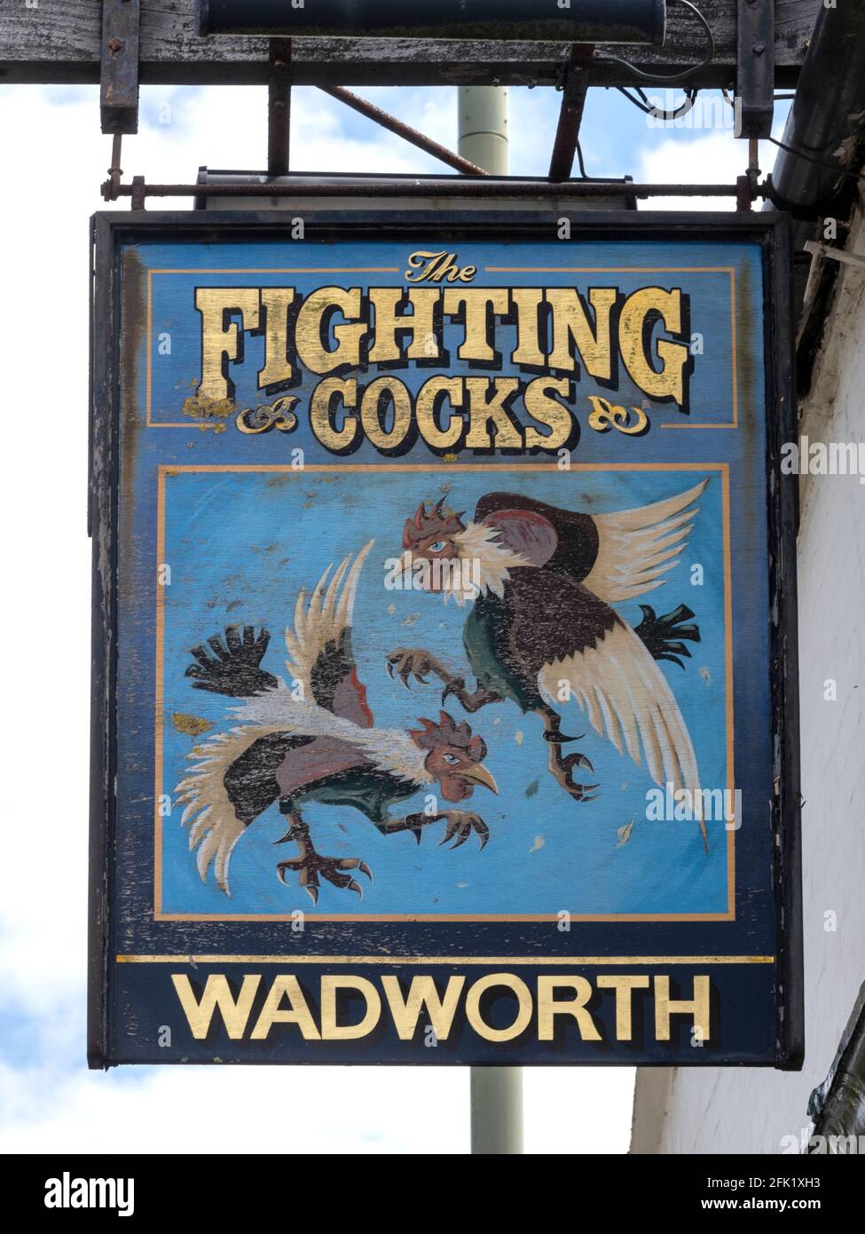 Traditional hanging pub sign at The Fighting Cocks public house