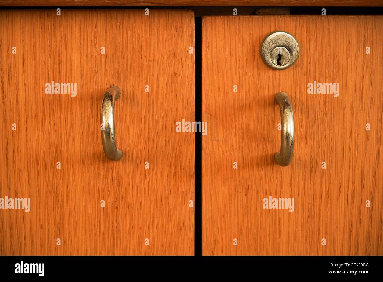Close up to locked wooden cabinet. Stock Photo