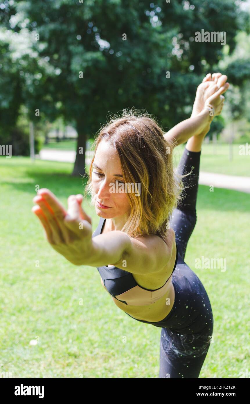 girl doing yoga in the park. front view. Lord of the dance pose Stock ...