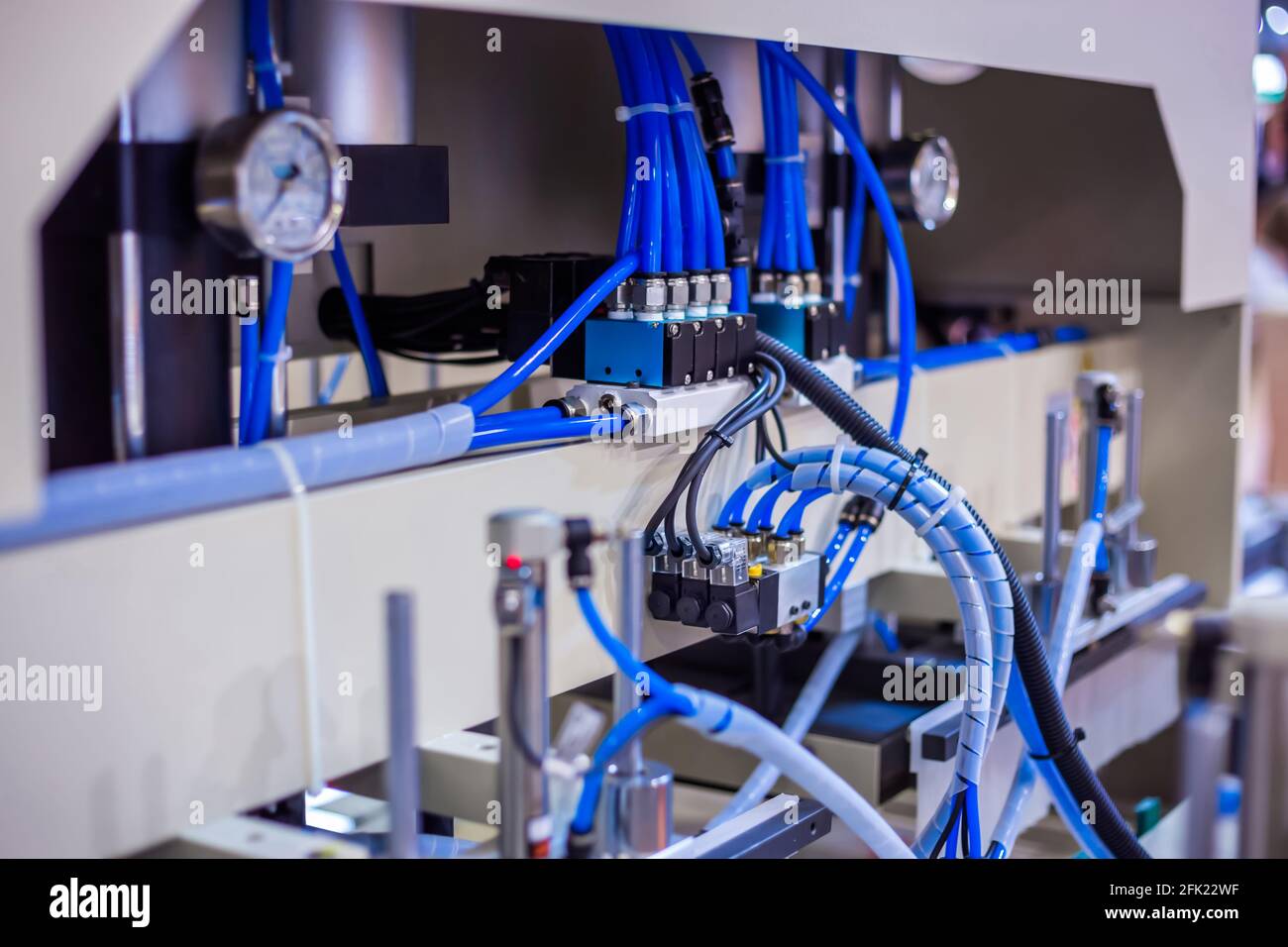 Part of automatic injection molding machine and plastic hoses at