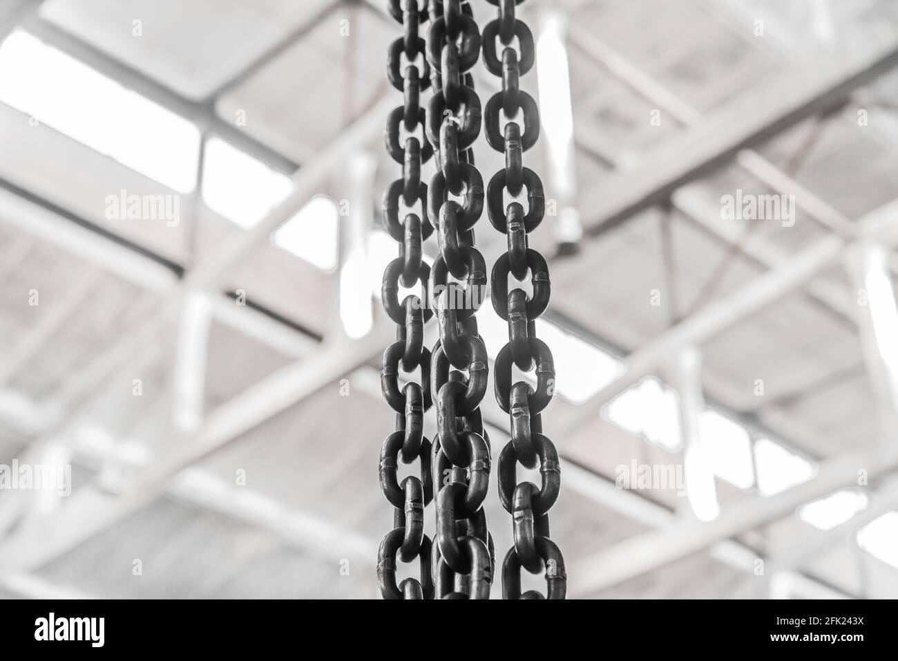 https://c8.alamy.com/comp/2FK243X/plant-equipment-chain-with-iron-links-of-the-lifting-mechanism-of-an-overhead-crane-against-the-background-of-an-industrial-workshop-or-factory-2FK243X.jpg