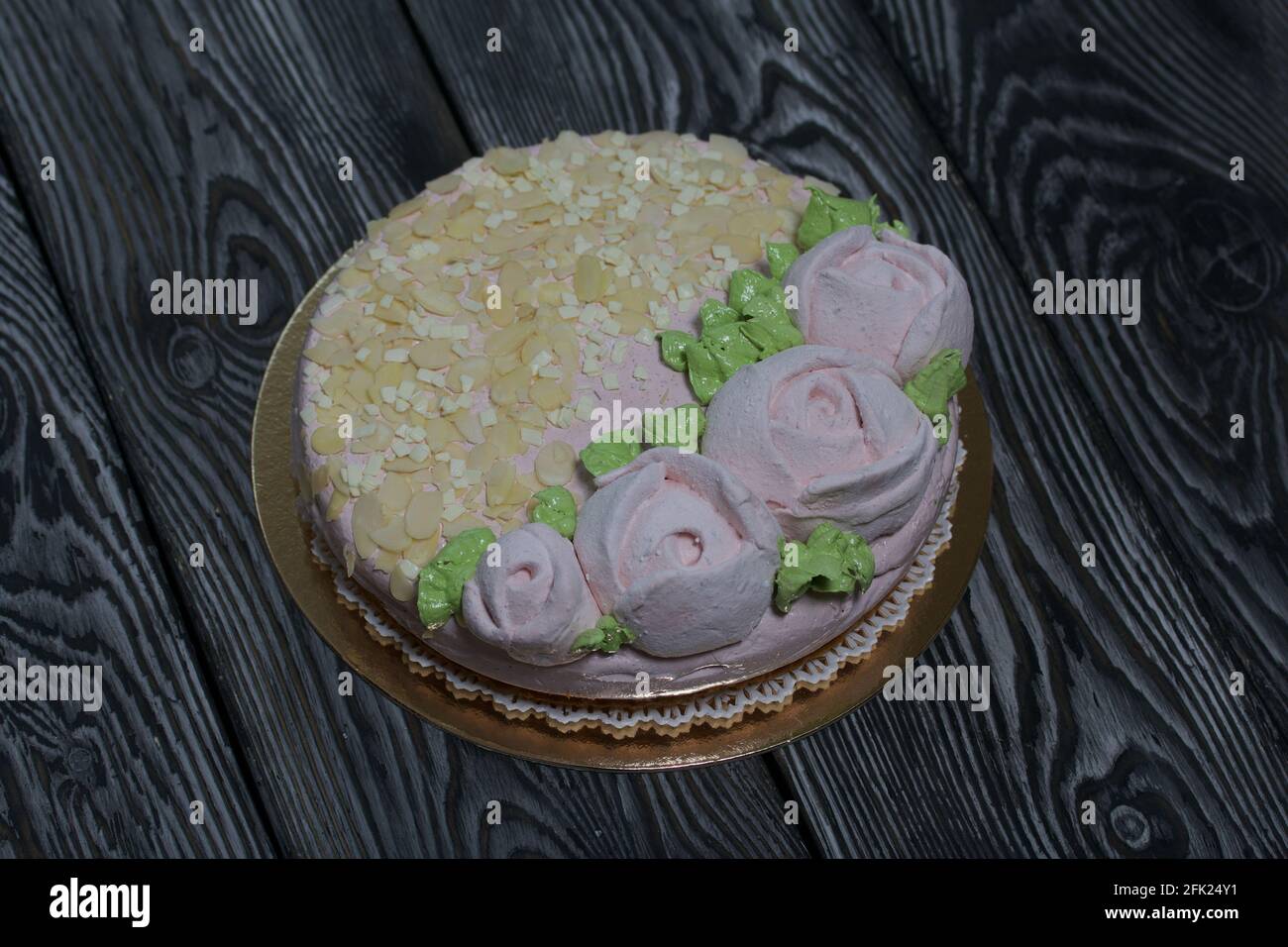 Marshmallow cake. Layers of biscuit, marshmallow and jelly. Decorated with marshmallow roses and