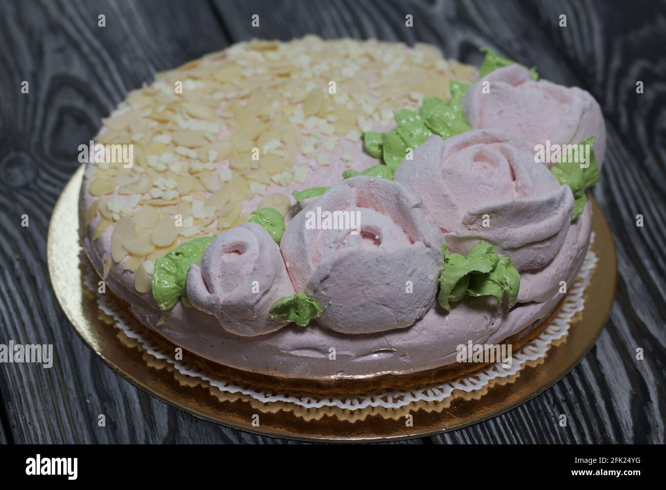 Marshmallow cake. Layers of biscuit, marshmallow and jelly. Decorated with marshmallow roses and