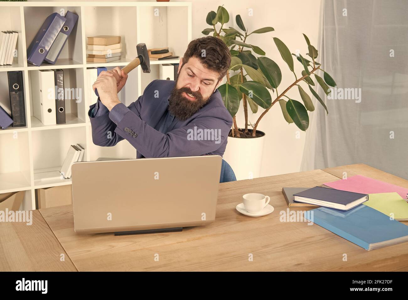 hate my job. dealing with error. overworked man crush laptop with hammer.  frustrated computer user. businessman express anger. ready to smash. Office  Stock Photo - Alamy