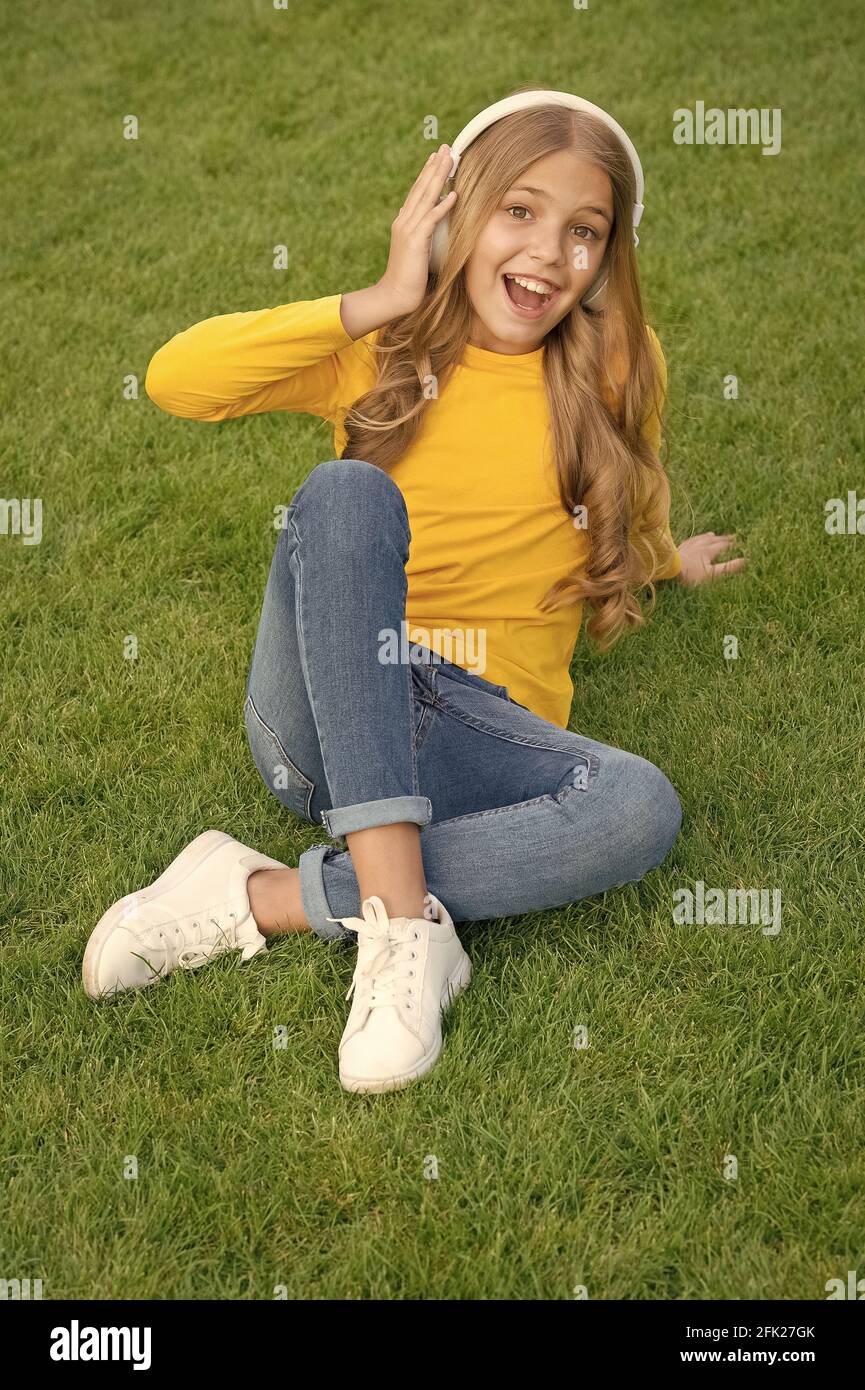 User Favorites  Image teen girls  spring mood playlist. happy little girl listen favorite song. kid beauty  fashion. teen girl listen music. sounds of nature. relax on green grass  Stock Photo - Alamy