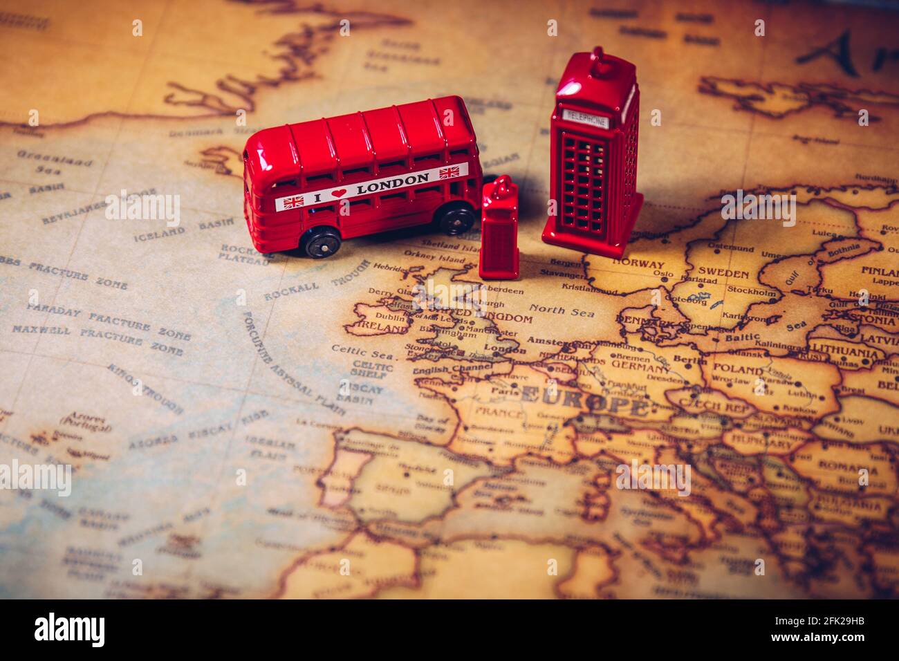 The iconic red bus and Big Ben miniature with compass on the map of London, UK. Concept of travel. Stock Photo