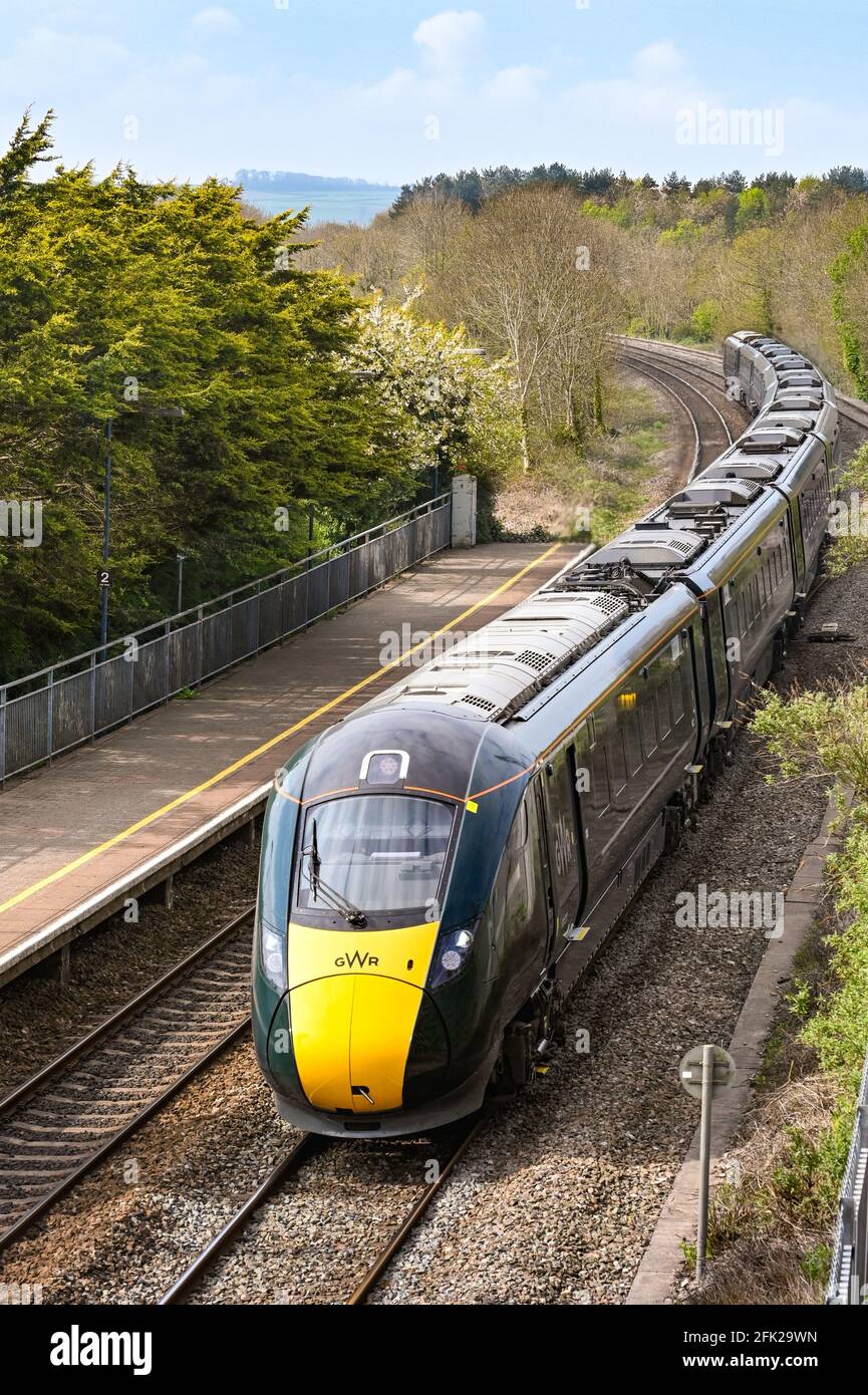 Pencoed, near Bridgend, Wales - April 2021: High speed train passing the railway station in the village of Pencoed. Stock Photo
