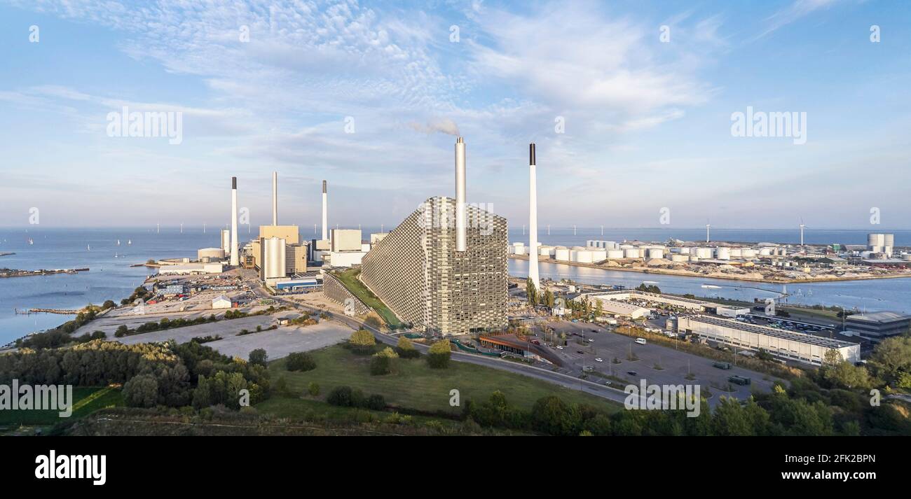 Distant view with clouds and waterways. CoppenHill Power Plant, Copenhagen, Denmark. Architect: BIG Bjarke Ingels Group, 2019. Stock Photo
