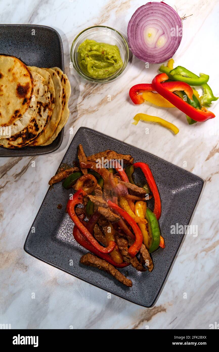 Mexican steak fajitas with fried corn tortillas and guacamole Stock