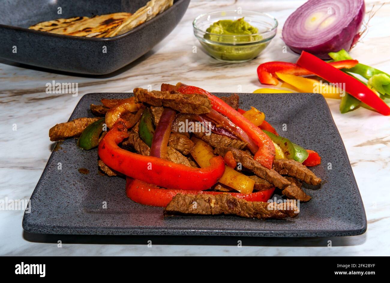 Mexican steak fajitas with fried corn tortillas and guacamole Stock