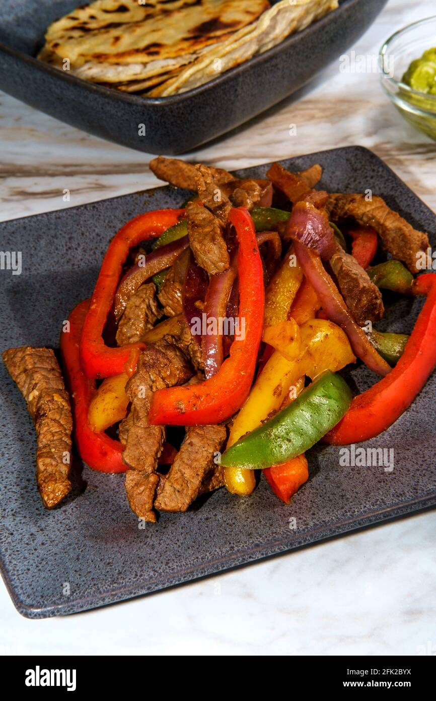 Mexican steak fajitas with fried corn tortillas and guacamole Stock