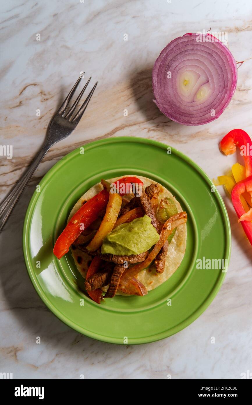 Mexican steak fajitas with fried corn tortillas and guacamole Stock