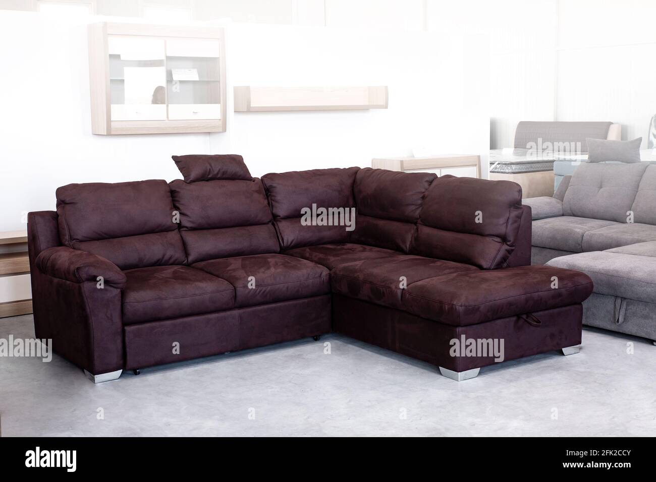 Modern design living room interior with corner sofa in a brown color Stock  Photo - Alamy