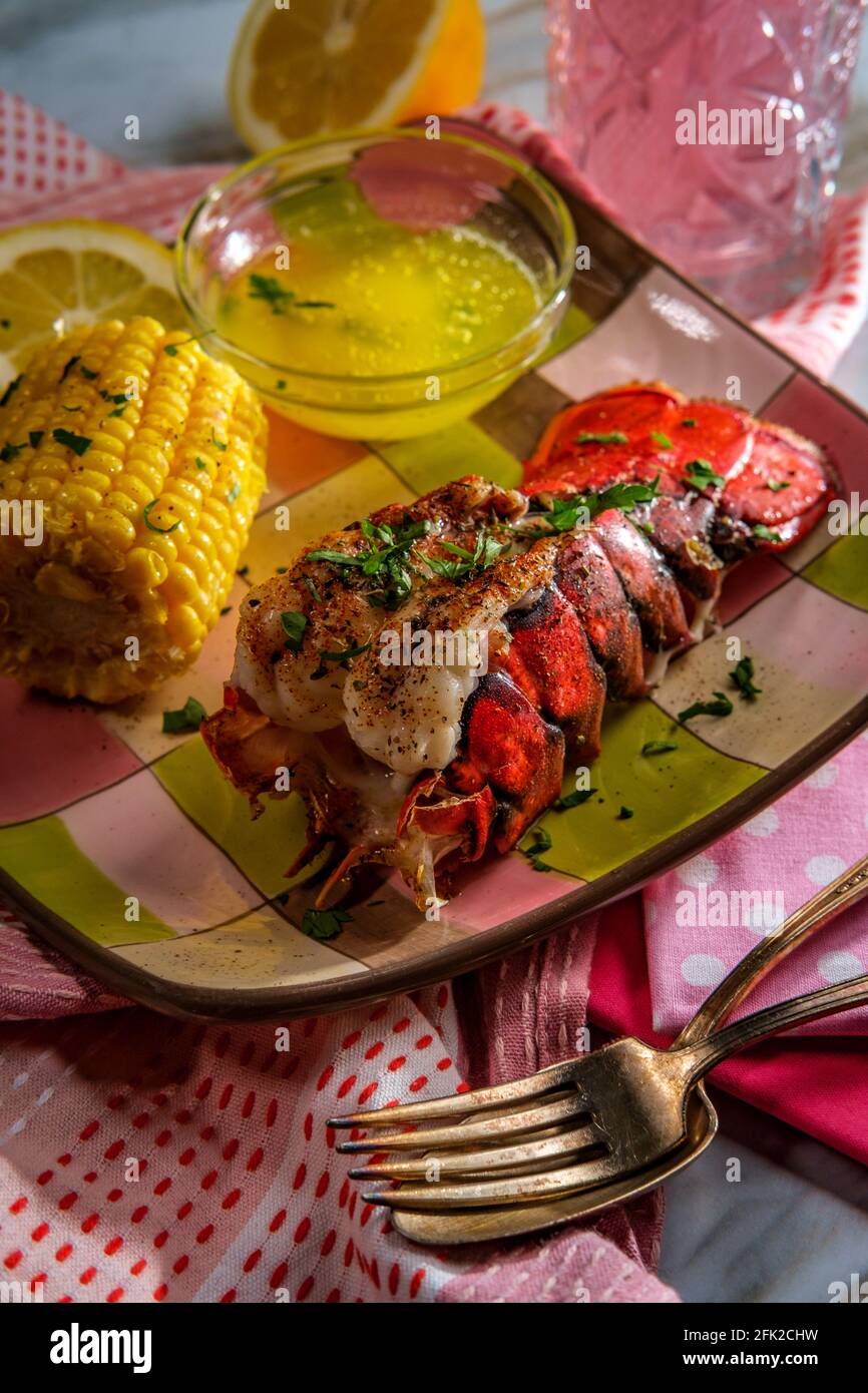 Italian seafood grilled lobster tail with corn on the cob and melted