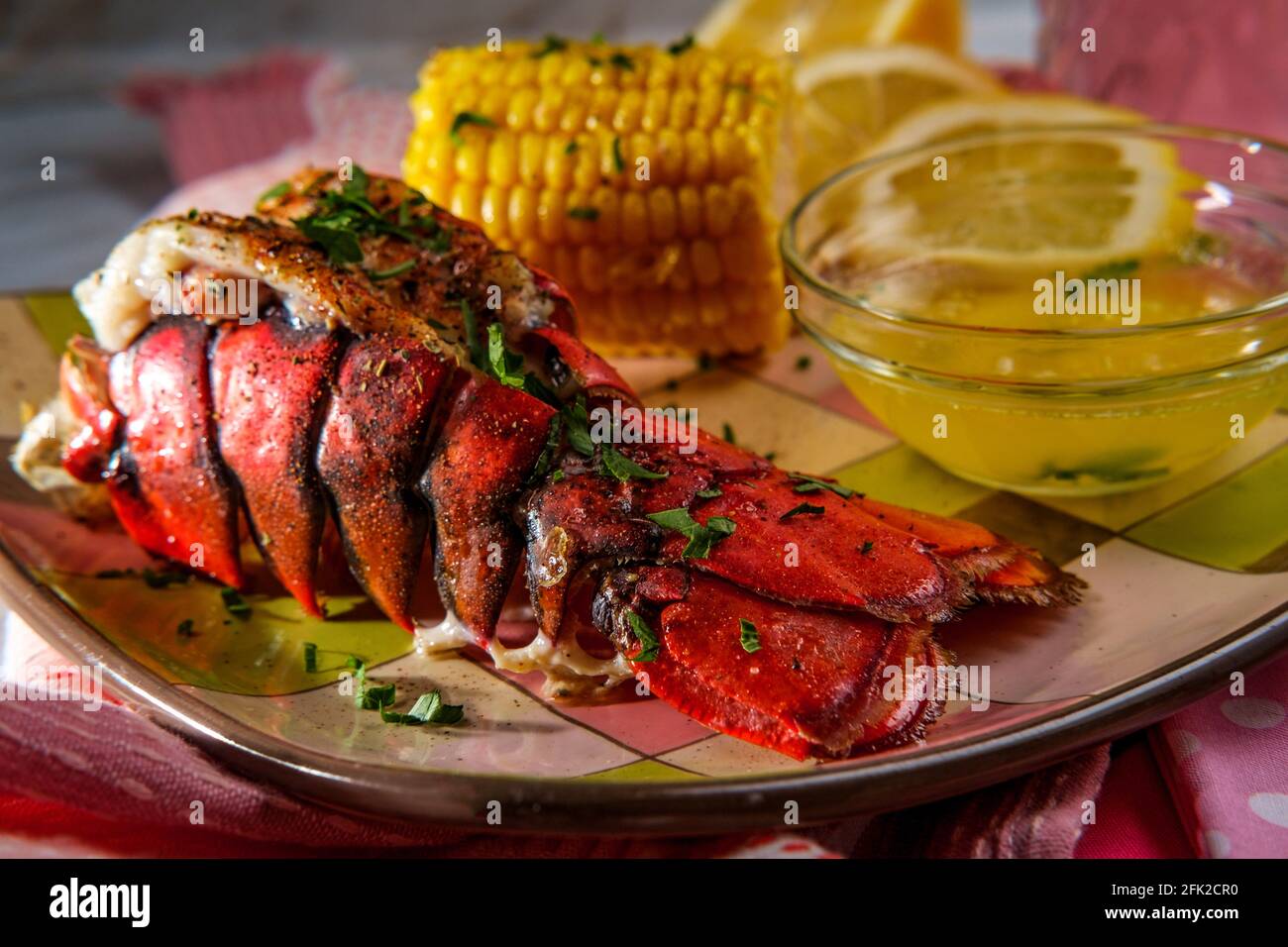 Italian seafood grilled lobster tail with corn on the cob and melted