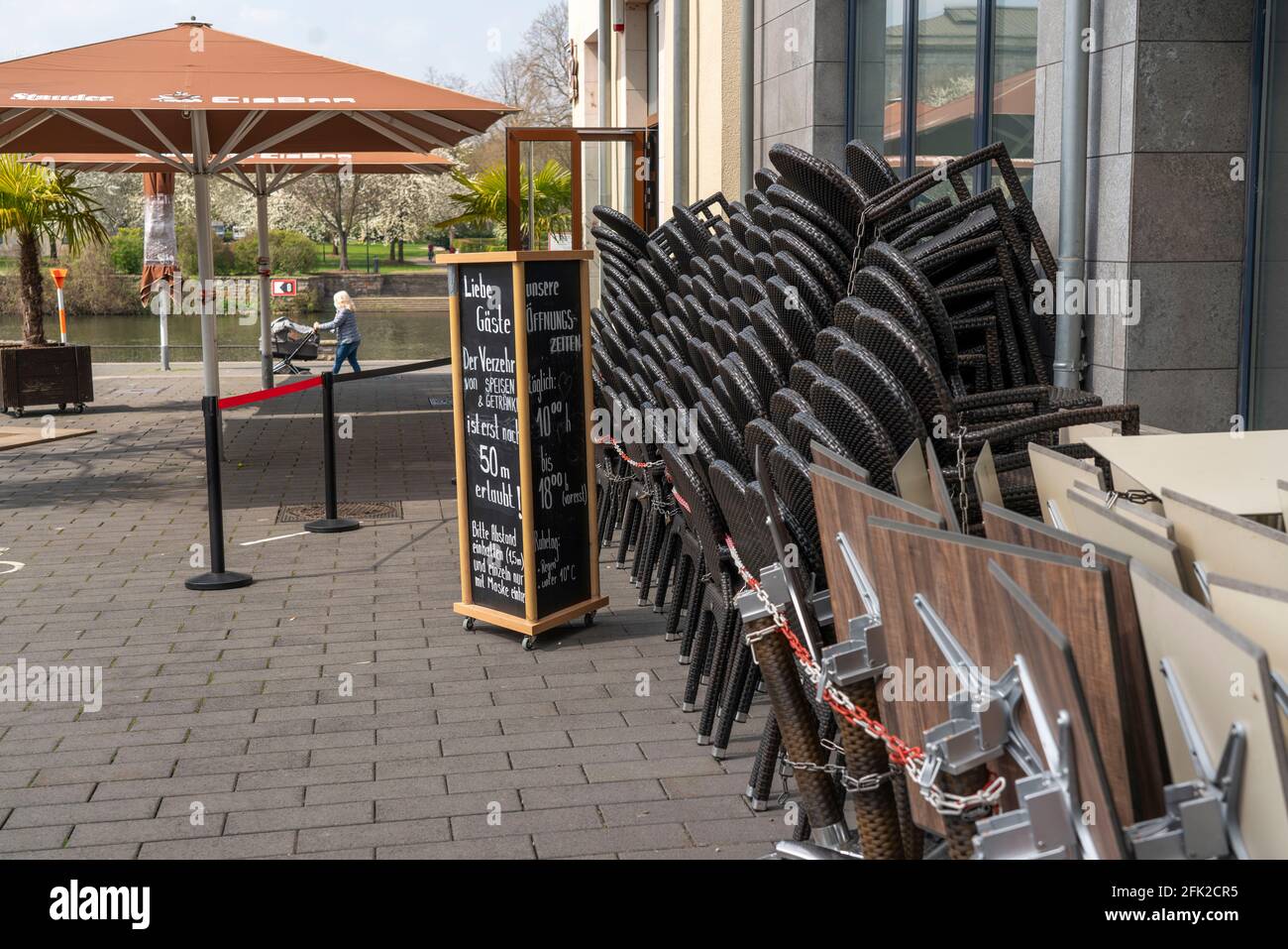 Closed gastronomy, during the Corona condition lockdown in April 2021, outdoor gastronomy, stacked tables and chairs, at the Ruhr promenade,  Am Stadt Stock Photo