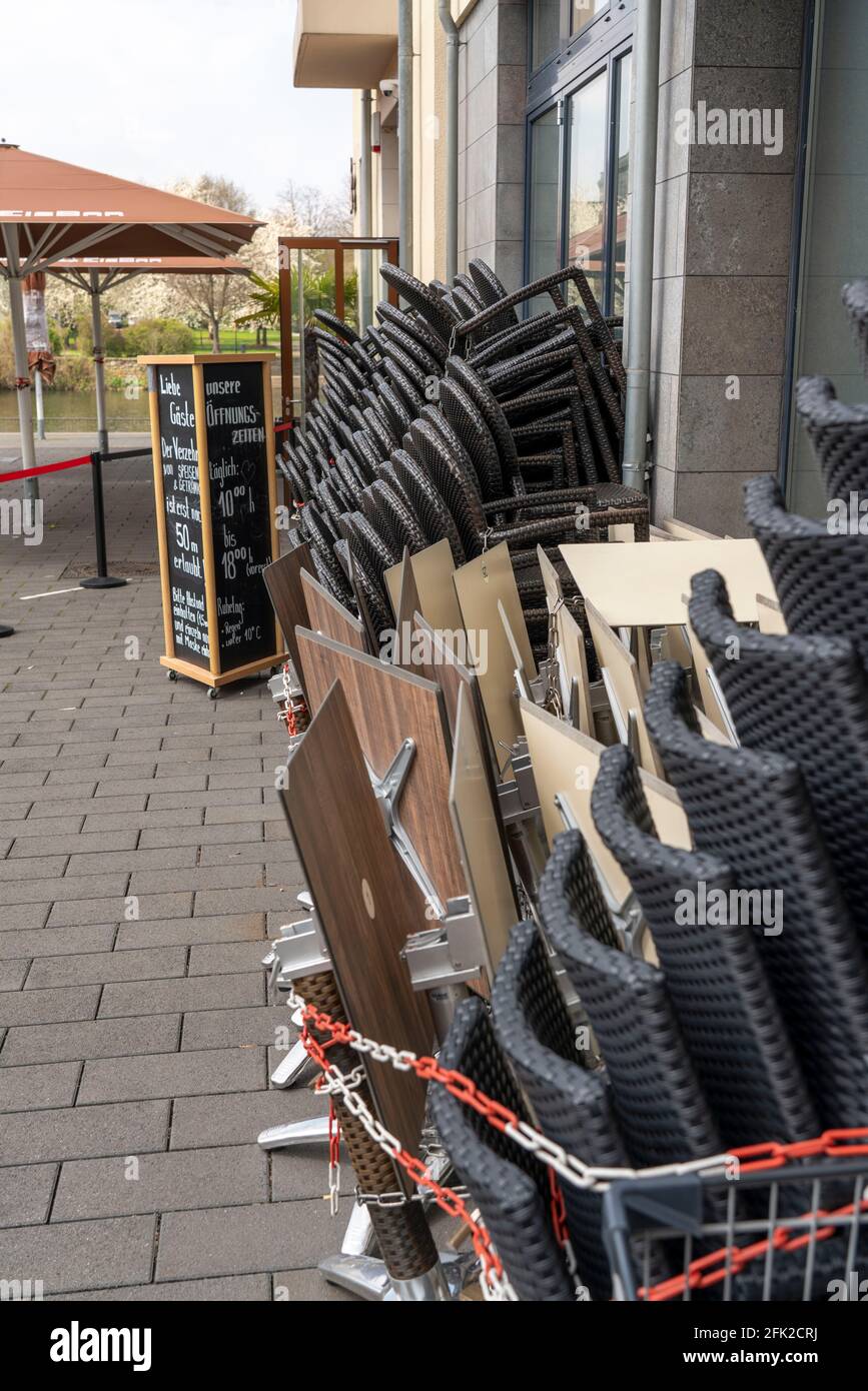 Closed gastronomy, during the Corona condition lockdown in April 2021, outdoor gastronomy, stacked tables and chairs, at the Ruhr promenade,  Am Stadt Stock Photo