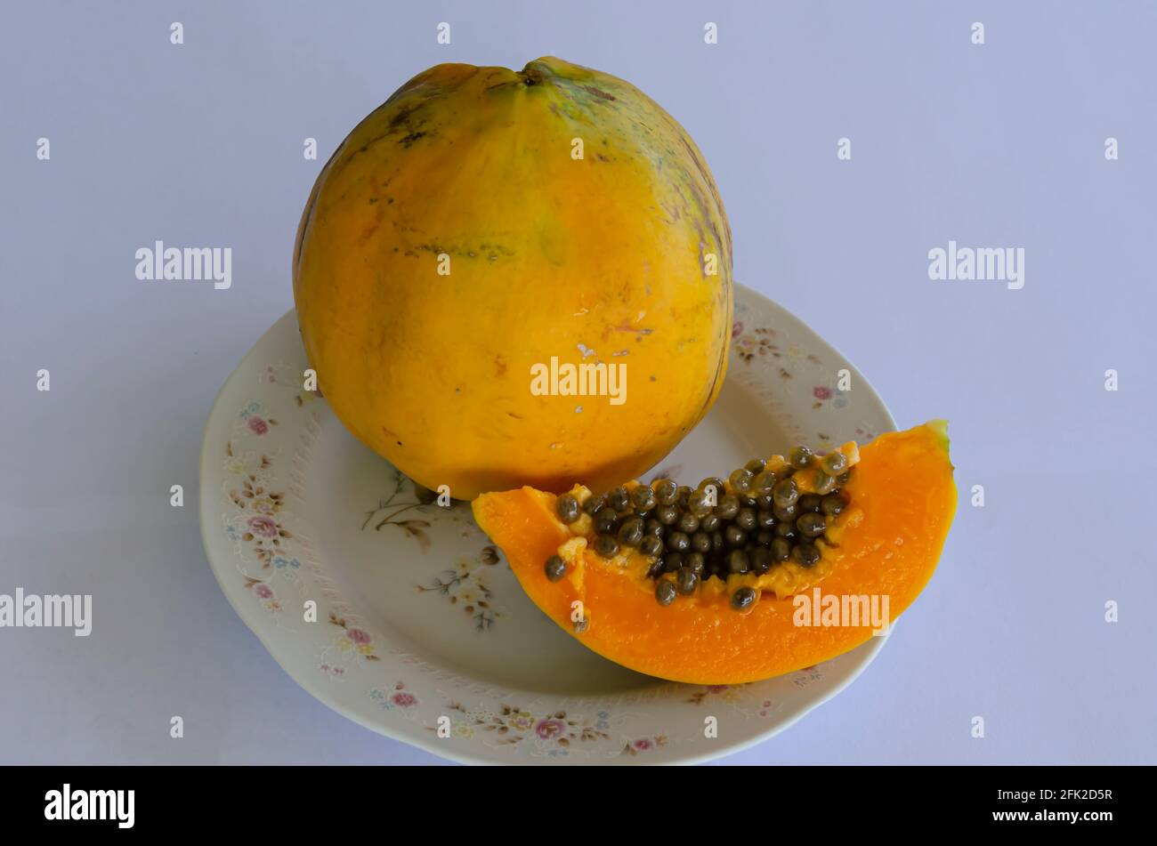 Papaya In Floral Plate Stock Photo
