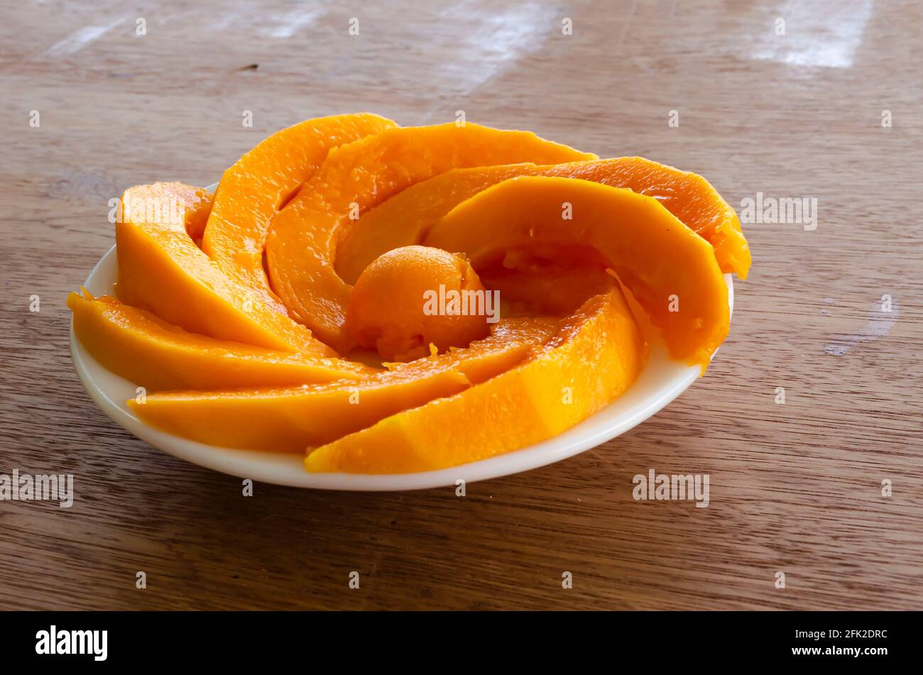 Papaya Slices Arranged In Swirl Stock Photo