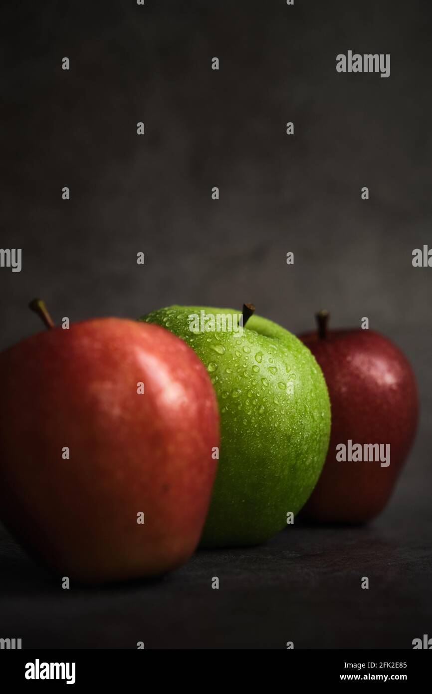 three apples on a dark background Stock Photo