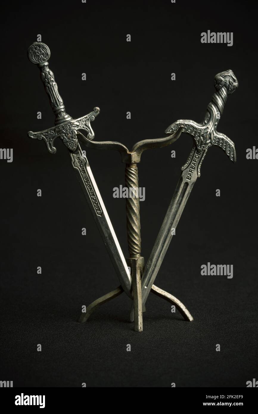 two steel swords letter opener on black background Stock Photo
