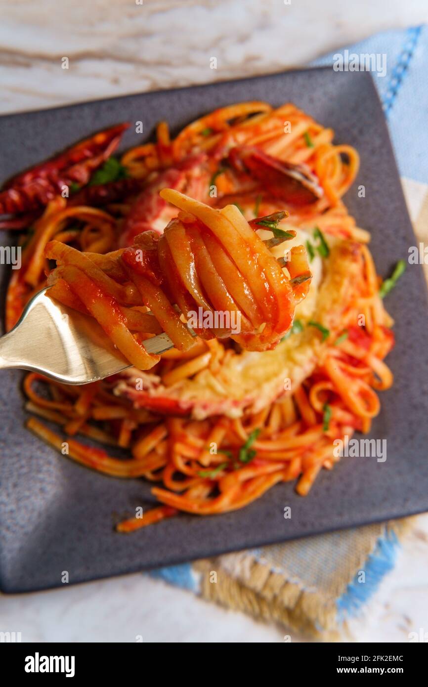 Pan fried sliced Italian lobster tail fra diavolo linguine Stock Photo