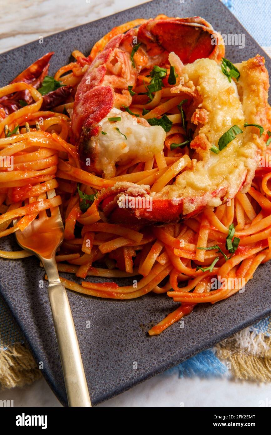 Pan fried sliced Italian lobster tail fra diavolo linguine Stock Photo