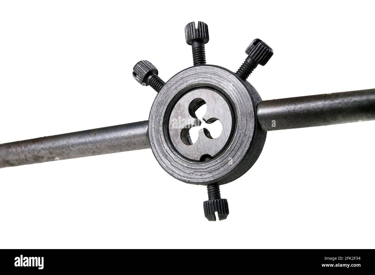 A metal die in a holder for cutting a metric thread. Accessories used ...