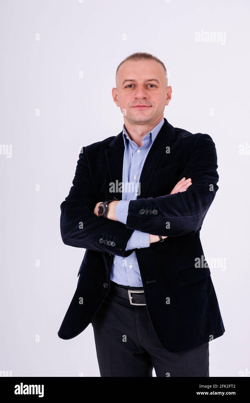 Man wearing a blue shirt, black pants and a blue jacket on a white  background Stock Photo - Alamy
