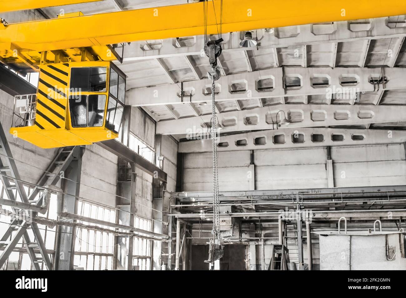 Overhead crane hoist equipment in an industrial plant transports an