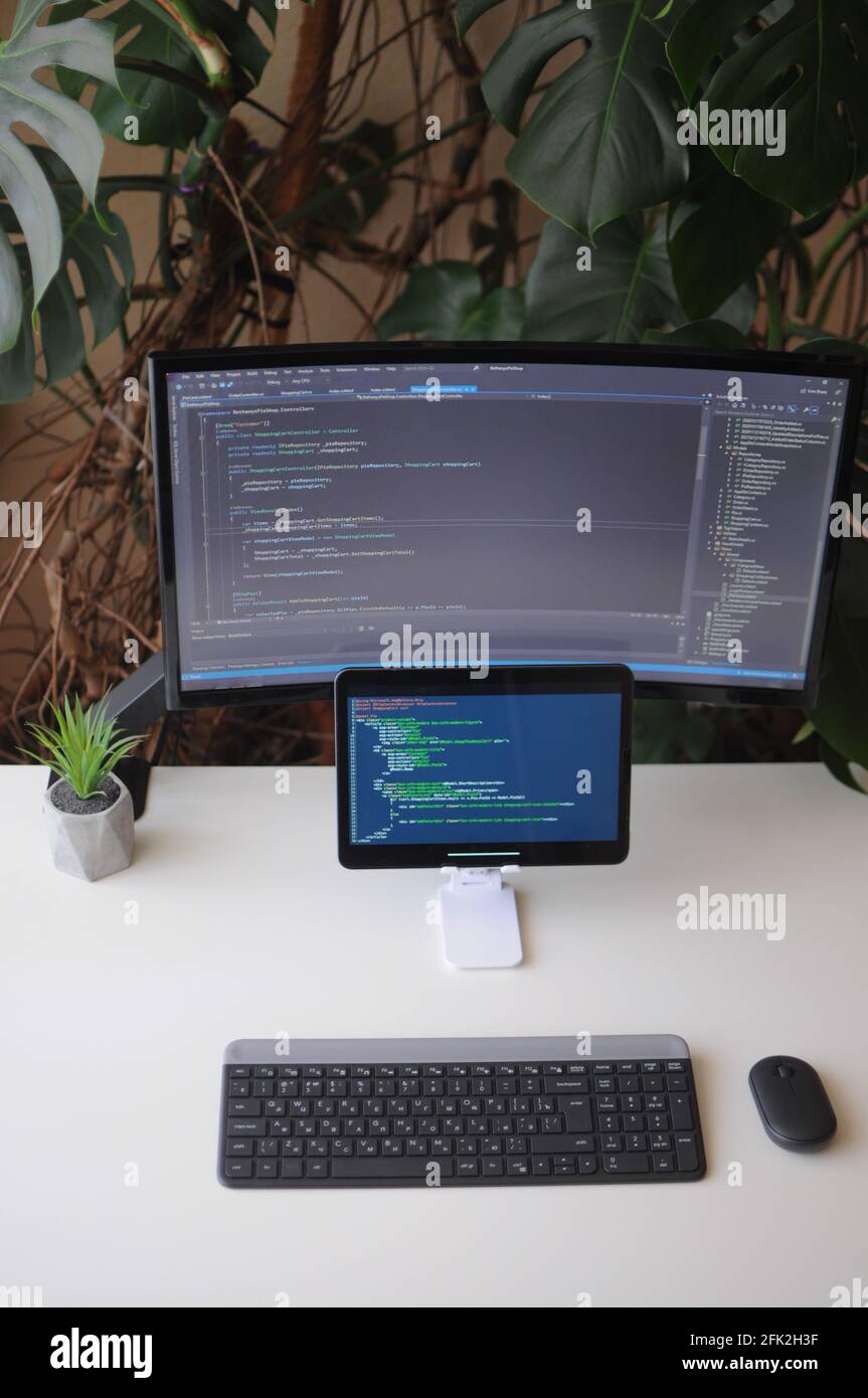 Work place for developer, screen and tablet with code. Comfort working ...