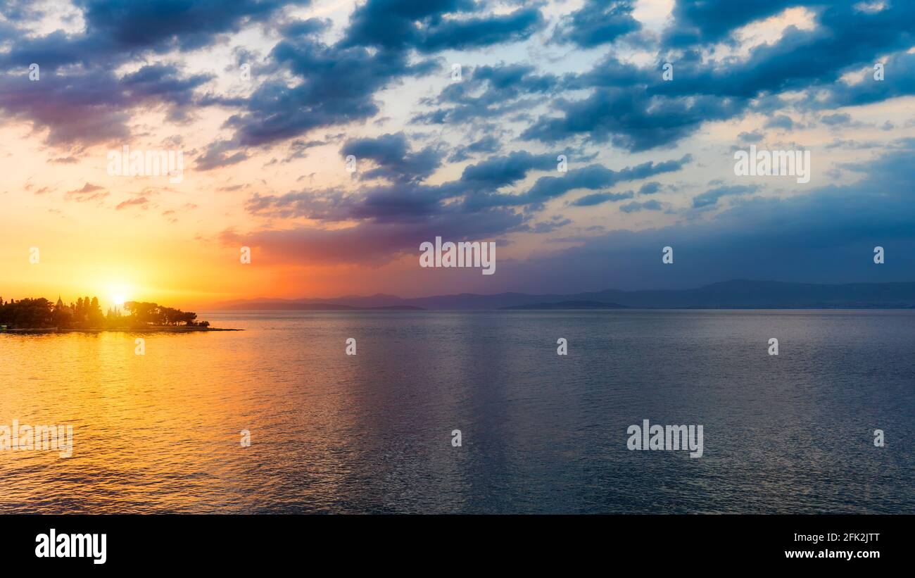 Sunset or sunrise sky above the sea. Nature, weather, atmosphere, travel theme. Sunrise or sunset over the sea. Panorama Stock Photo