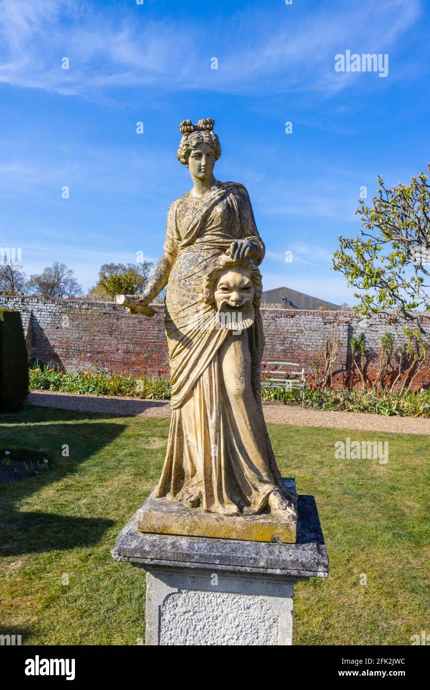 Statue of a Greek Muse, probably Melpomene, in the gardens of Dunsborough Park, Ripley, Surrey, south-east England in April Stock Photo