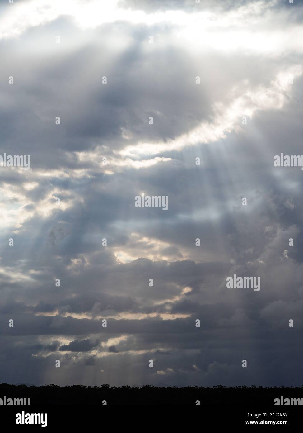Sunshine beaming it's rays through the clouds Stock Photo - Alamy