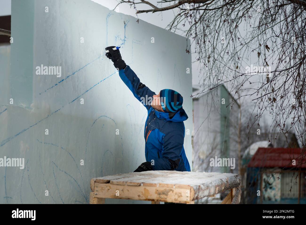 The artist draws the contours of the future ice figure on the ice Stock Photo