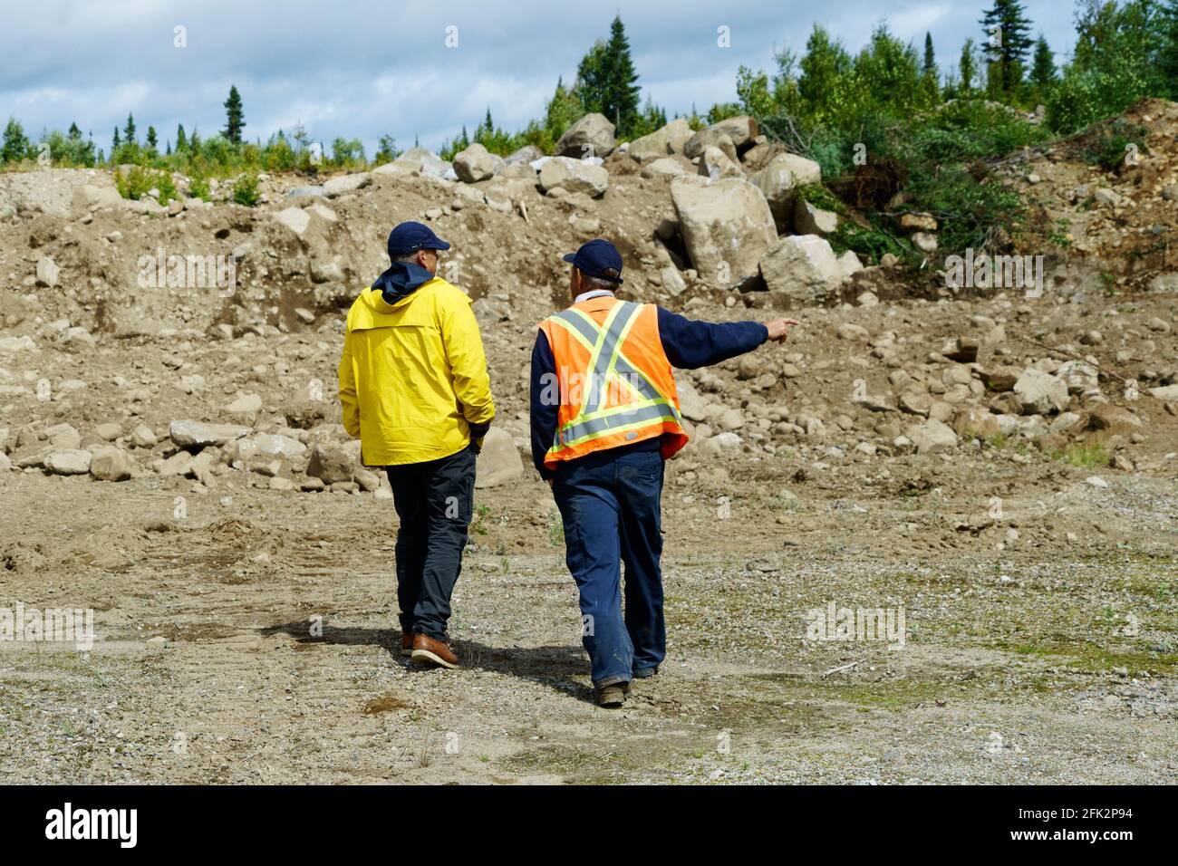 Two construction workers discussing in the Monts Valin region, province of Quebec, Canada. Stock Photo