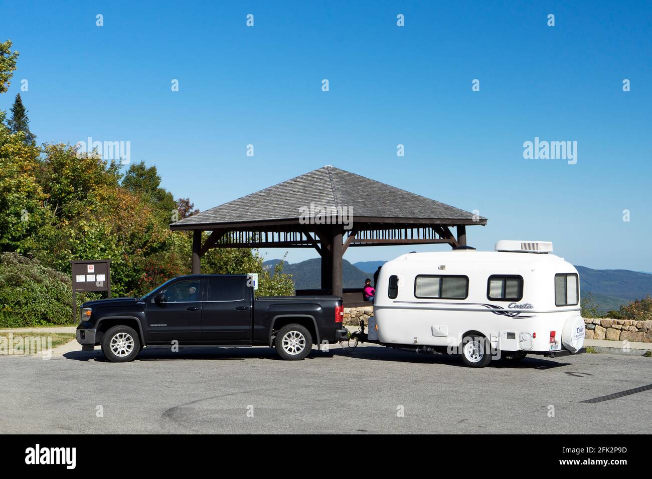 Sierra pickup truck with Casita camper in tow parked at an outlook on Kancamagus Highway, New Hampshire, USA. Stock Photo
