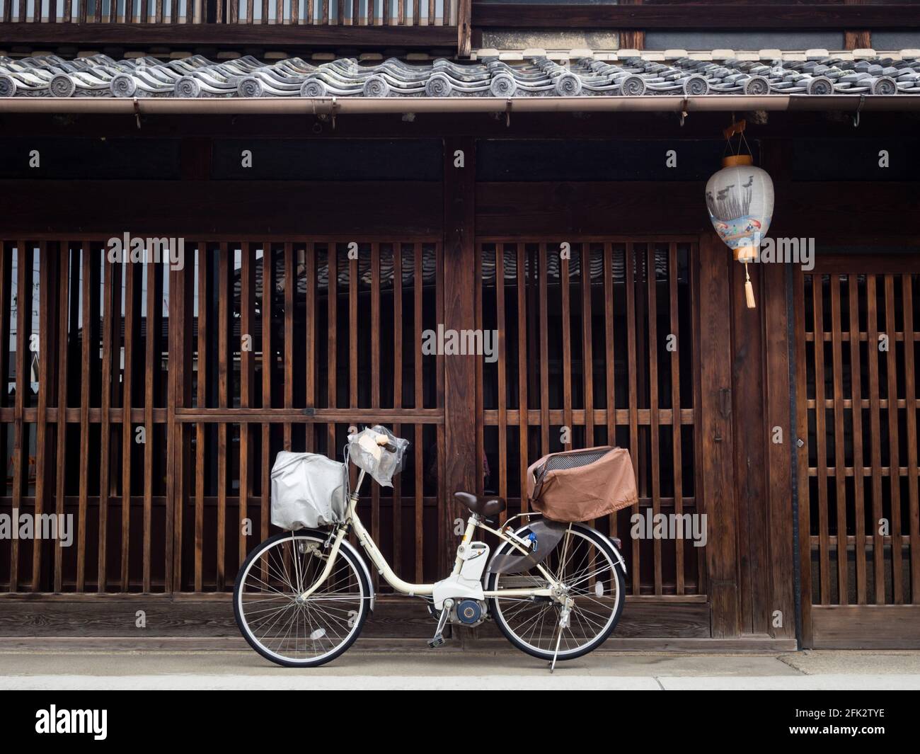 Gifu, Japan - October 5, 2015: Bicycle parked in front of traditional Japanese house on historic Kawaramachi street Stock Photo