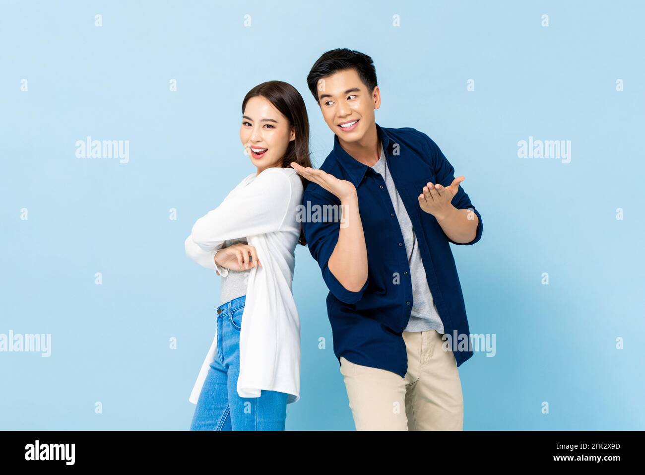 Portrait of happy attractive smiling Asian couple on isolated light ...