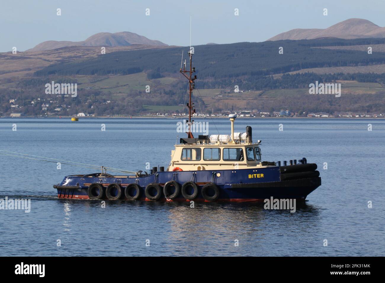 Biter, a Damen Stan 1 tug operated by Clyde Marine Services, assisting PS Waverley into Garvel Dock, on the Firth of Clyde.. Stock Photo