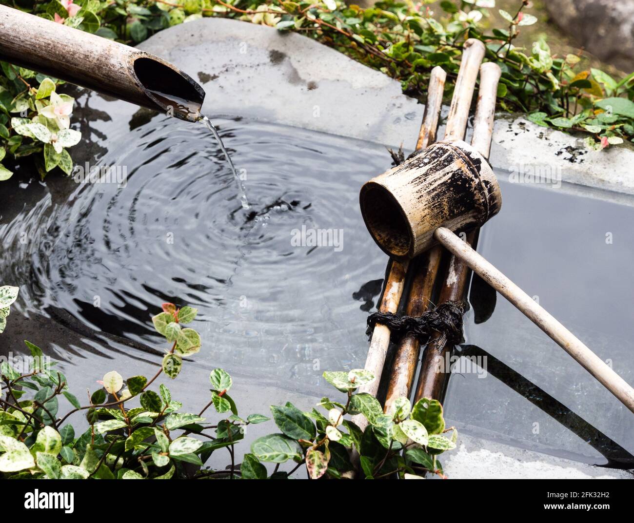 Decorative stone water basin in traditional Japanese garden Stock Photo