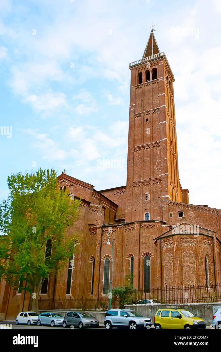 The brick building of the medieval Gothic Santa Anastasia Basilica with tall bell tower, view from the Piazza Bra Molinari square, Verona, Italy Stock Photo