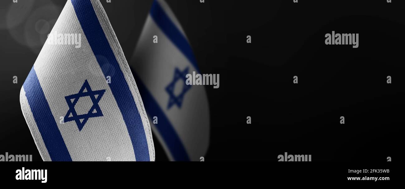 Small national flags of the Israel on a dark background Stock Photo