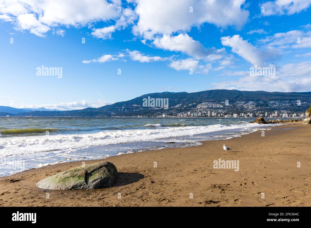Third Beach, Stanley Park Seawall. West Vancouver cityscape in the background. British Columbia, Canada. Stock Photo
